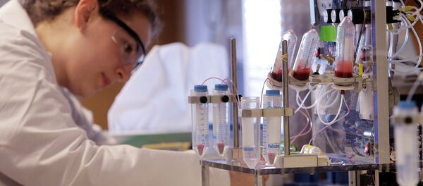 A researcher works near a blood test machine - سبوتنيك عربي