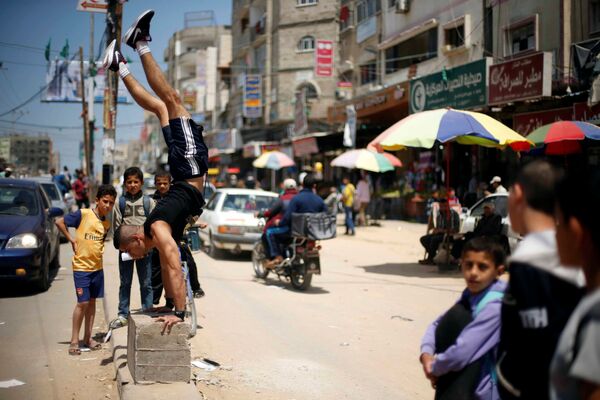 الفلسطيني محمد الحر خلال ممارسته لرياضة الباركور في مخيم النصيرات للاجئين في قطاع غزة، فلسطين 2 مايو/ آيار 2017 - سبوتنيك عربي