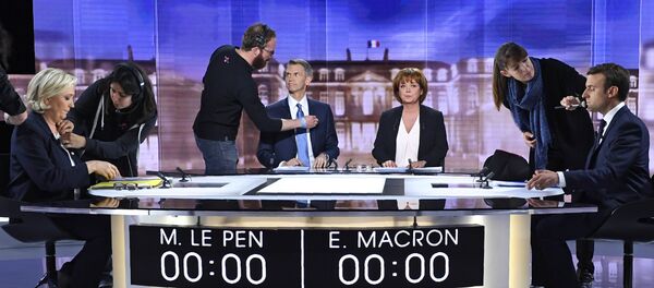 لوبان وماكرون أثناء المناظرة بينهما - سبوتنيك عربي