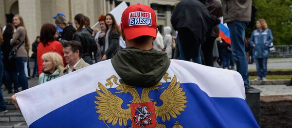 Участник праздничного митинга в честь Дня России на площади Ленина в Новосибирске Участник праздничного митинга в честь Дня России на площади Ленина в Новосибирске - سبوتنيك عربي