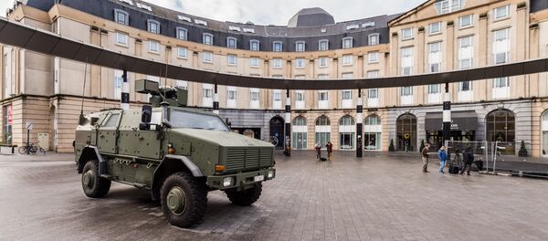 A Belgian Army vehicle is parked on the almost deserted square in front of the main train station in the center of Brussels on Sunday, Nov. 22, 2015. - سبوتنيك عربي