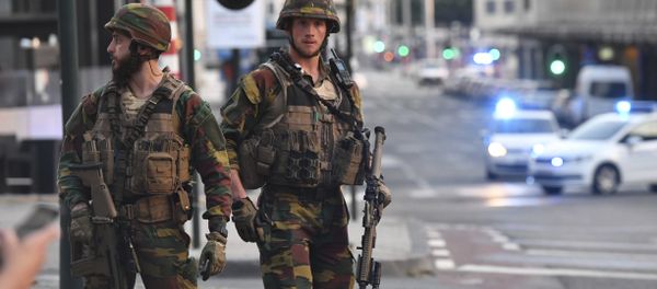 In this image taken from video, police cars create a cordon near the train station in central Brussels, Tuesday June 20, 2017. Belgian media report that explosion-like noises have been heard at a Brussels train station; the main square evacuated. In this image taken from video, police cars create a cordon near the train station in central Brussels, Tuesday June 20, 2017. Belgian media report that explosion-like noises have been heard at a Brussels train station; the main square evacuated. - سبوتنيك عربي