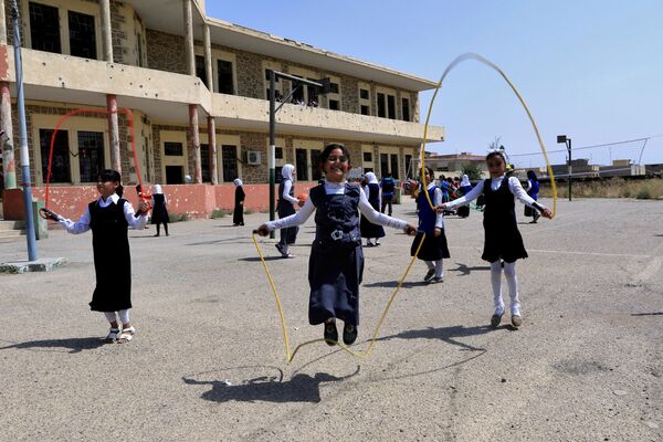 فتيات عراقيات يلعبن في ساحة المدرسة في الموصل، العراق 18 يوليو/ تموز 2017 - سبوتنيك عربي