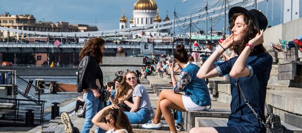 فتيات تستمتعن بأشعة الشمس على ضفة نهر موسكو في حديقة غوركوغو بموسكو، 19 يوليو/ تموز 2017 - سبوتنيك عربي