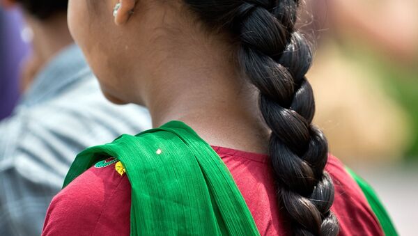 A Indian girl with a traditional hair style walks in New Delhi. (File) - سبوتنيك عربي