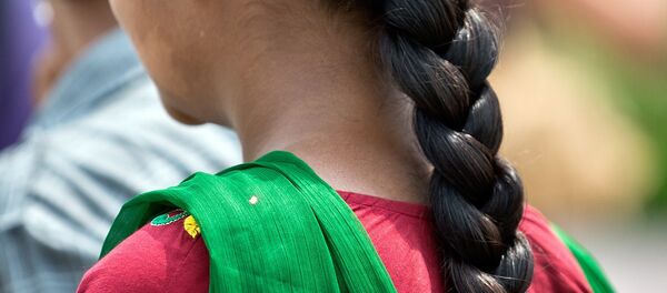 A Indian girl with a traditional hair style walks in New Delhi. (File) - سبوتنيك عربي