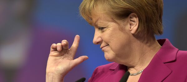 German Chancellor and chairwoman of the German Christian Democrats, CDU, Angela Merkel, points with her fingers during a visit to the convention venue prior to the 27. party convention in Cologne, Germany, Monday, Dec. 8, 2014. - سبوتنيك عربي