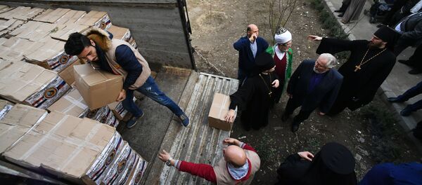 وفد من الشخصيات الدينية في روسيا يزور دمشق - توزيع المساعدات الإنسانية - سبوتنيك عربي