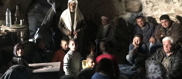 لاجئون كرديون يختبئون من الضربات الجوية التركية في منطقة جبلية في ضواحي عفرين شمال سوريا - سبوتنيك عربي