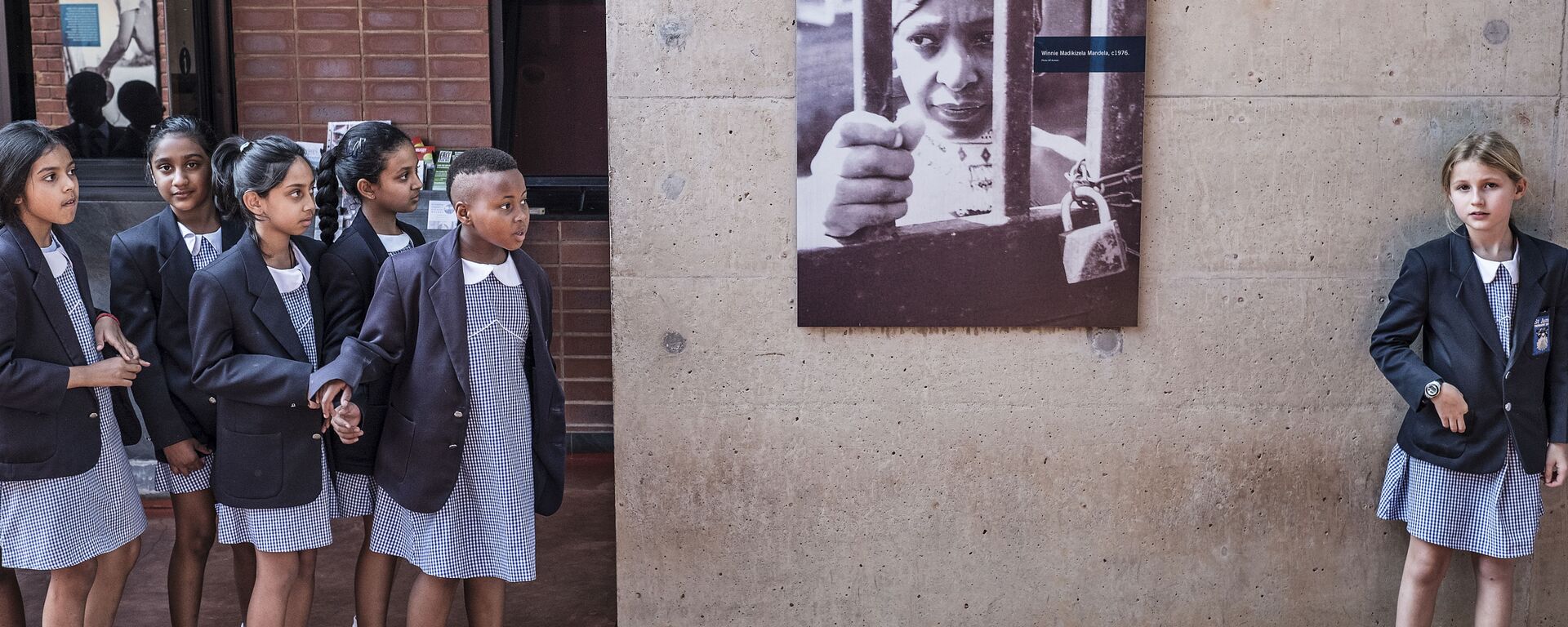 أطفال المدارس في جنوب أفريقيا يتوفون أمام صورة للناشطة المناهضة لنظام الفصل العنصري في جنوب أفريقيا ويني ماديكيزيلا - مانديلا، الزوجة السابقة لزعيم المؤتمر الوطني الأفريقي نيلسون مانديلا، على جدار منزلها في سويتو 3 أبريل/ نيسان  2018   - سبوتنيك عربي, 1920, 14.01.2022