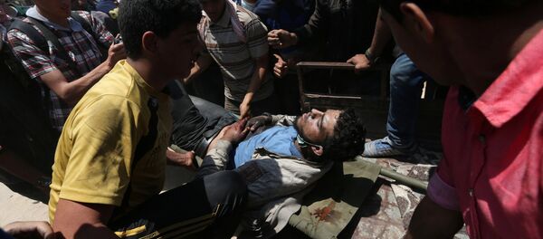 سقوط جرحى و مصابين في احتجاجات تعم البلاد ضد نقل السفارة الأمريكية إلى القدس عشية الذكرى الـ 70 لـ النكبة ، شرق غزة، قطاع غزة، فلسطين 14 مايو/ أيار 2018 - سبوتنيك عربي