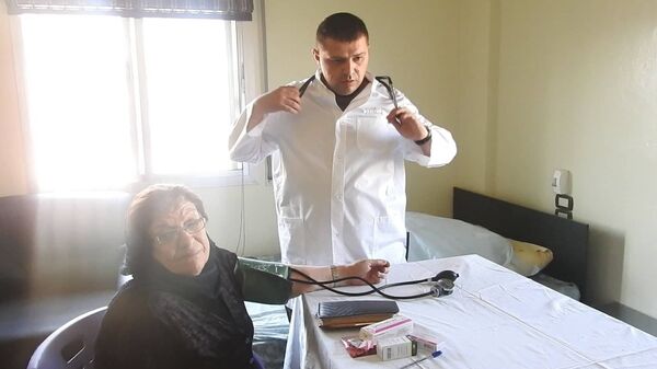 طبيب روسي يقوم بمعالجة مسنة سورية في ريف حماة - سوريا - سبوتنيك عربي