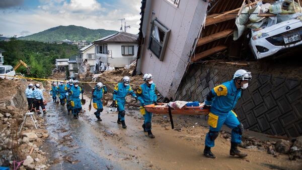 وصول طواقم الانقاذ ورجال الشرطة لاتمام عمليات الانقاذ في منطقة كومانو، هيروشيما، اليابان 9 يوليو/ تموز 2018 - سبوتنيك عربي