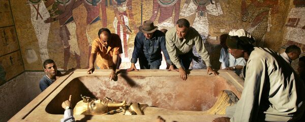 رئيس الآثار المصرية زاهي حواس (وسط الصورة تقريبا) يشرف على إزالة الملك توت عنخ آمون من التابوت الحجري في قبره تحت الأرض بوادي الملوك الشهير في الأقصر، في 4 نوفمبر/ تشرين الثاني 2007. تم الكشف عن الوجه الحقيقي للفرعون توت عنخ آمون، ملك مصر القديمة، للمرة الأولى منذ وفاته في ظروف غامضة منذ أكثر من 3000 سنة. وانتقلت مومياء الفرعون من تابوتها المزخرف، حيث أثار اكتسافه عام 1922 حدثا حصريا دوليا حول مكان الاحتفاظ به، حيث كما يقول الخبراء أنه سيتم الحفاظ عليها بشكل أفضل. - سبوتنيك عربي