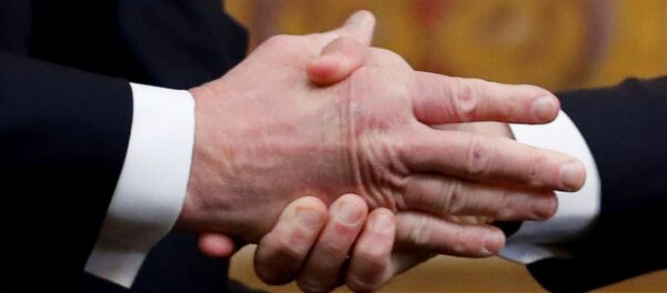 ترامب يصافح ماكرون أثناء لقائهما في قصر إليزيه كجزء من مراسم الاحتفال بيوم الهدنة بعد 100 عام على نهاية الحرب العالمية الأولى - سبوتنيك عربي