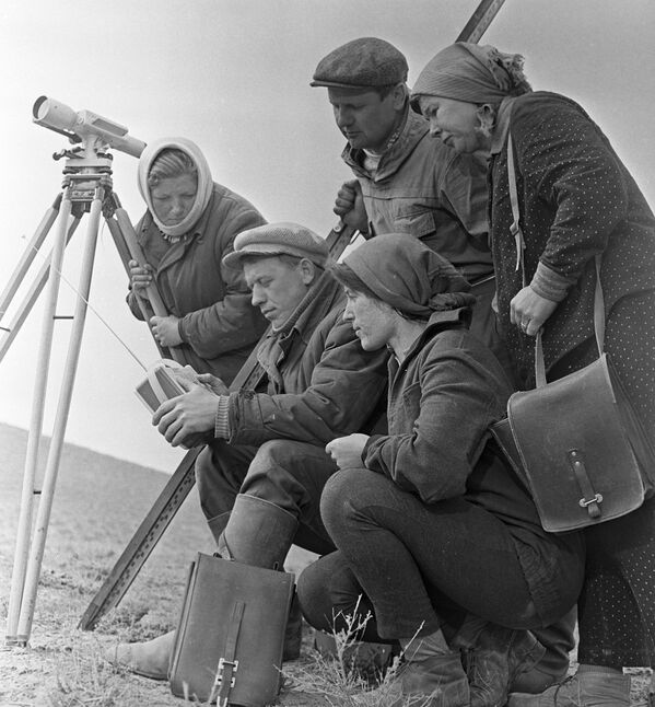 الطوبوغرافيون، المشاركون في بناء محطة كابتشاي الكهرومائية، يستمعون إلى الراديو خلال فترة استراحتهم - سبوتنيك عربي