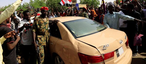 متظاهرون سودانيون يهتفون بشعارات أثناء احتجاجهم على إعلان الجيش بأن الرئيس عمر البشير سيحل محله مجلس انتقالي بقيادة الجيش في الخرطوم - سبوتنيك عربي