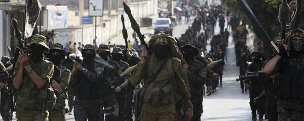 ملثمون فلسطينيون من سرايا القدس الجناح العسكري لجماعة الجهاد الإسلامي - سبوتنيك عربي