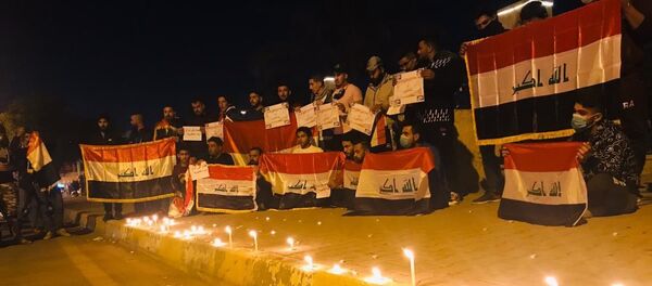 وقفة تضامنية مع الشهداء الذين سقطوا في الاحتجاجات العراقية، شارع الزهور وسط مدينة تكريت، العراق ديسمبر 2019 - سبوتنيك عربي