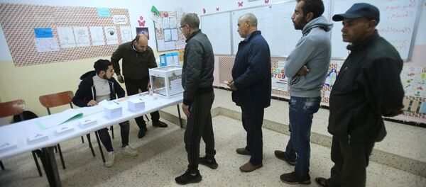ينتظر الناخبون استلام بطاقات الاقتراع في مركز الاقتراع خلال الانتخابات الرئاسية في الجزائر العاصمة - سبوتنيك عربي