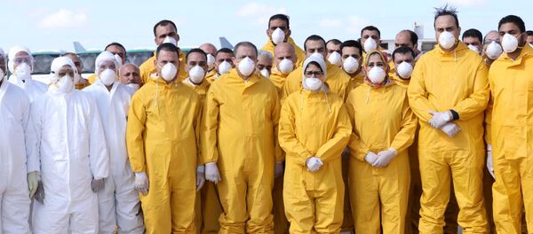 وزيرة الصحة المصرية هالة زايد تقف مع فريق طبي في مطار برج العرب في انتظار الركاب الذين تم إجلاؤهم من ووهان في الصين  - سبوتنيك عربي