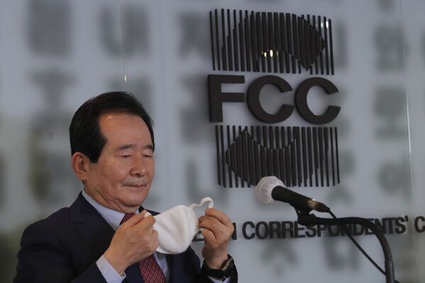 رئيس وزراء كوريا الجنوبية، تشونغ سي كيون، يخلع قناع وجهه لعقد مؤتمر صحفي حول التدابير الوقائية الأخيرة التي اتخذتها البلاد لمكافحة الفيروس التاجي كورونا الجديد في سيول في سئول، كوريا الجنوبية، 27 مارس 2020 - سبوتنيك عربي