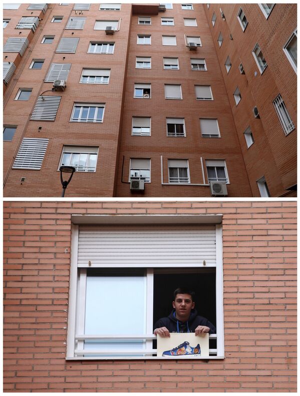 سيرخيو مارتينيز، 15 عاما، يعرض رسمته على نافذة منزله في مدريد، إسبانيا 23 أبريل 2020 - سبوتنيك عربي