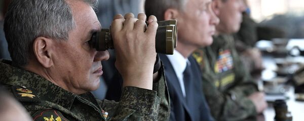 وزير الدفاع الروسي سيرغي شويغو والرئيس فلاديمير بوتين أثناء حضورهما للمناورات العسكرية في الميدان العسكري تسوغول منطقة ما وراء بايكال، 13 سبتمبر 2018 - سبوتنيك عربي