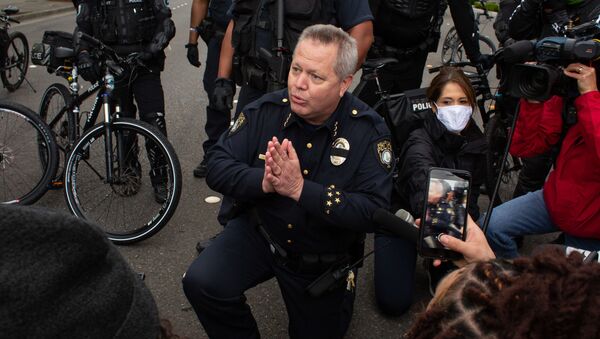 احتجاجات جورج فلويد - عناصر الشرطة الأمريكية يقفون على ركبة واحدة في إطار التضامن مع المتظاهرين في واشنطن، الولايات المتحدة 31 مايو 2020 - سبوتنيك عربي